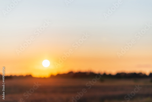 Blurred sunset landscape.Summer holiday concept. blurry beautiful sunlight and golden sunset background. © ARVD73