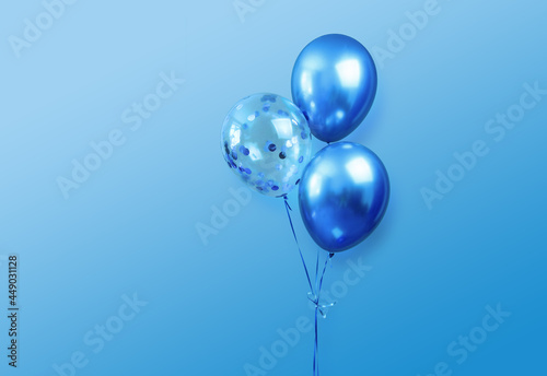 festive birthday party or holidays  background with 3 balloons close up. three blue  balloons isolated on blue background with copy space for text. background for birthday greeting card 