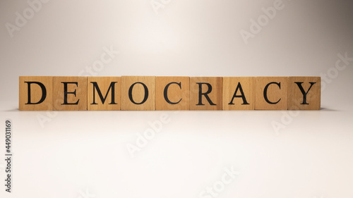 The name Democracy was created from wooden letter cubes. Economics and finance.