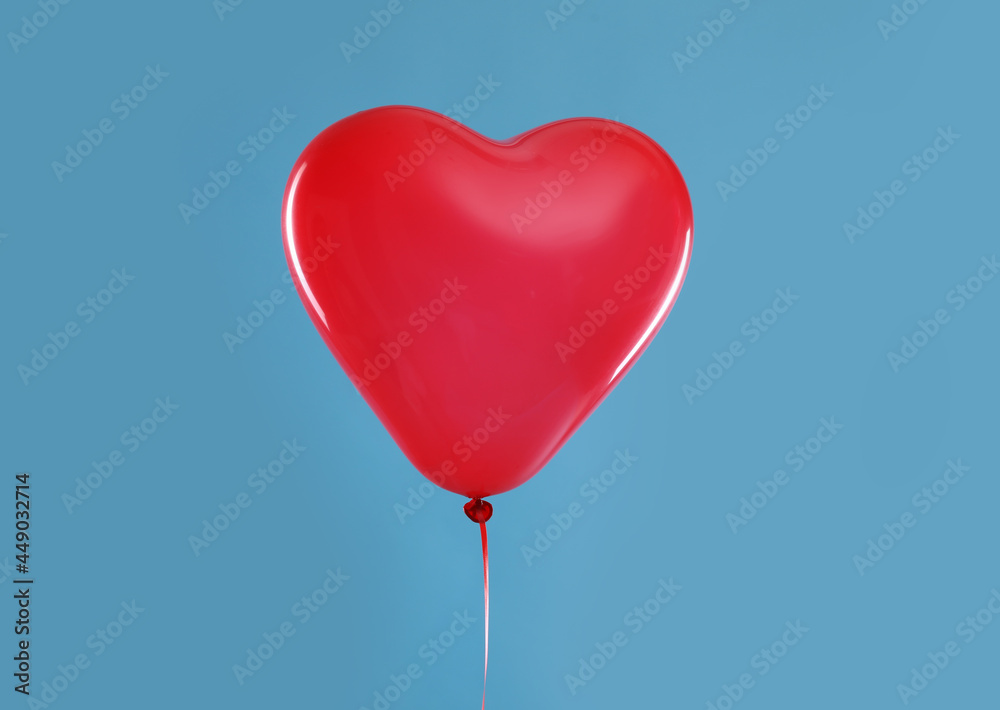 Festive heart shaped balloon on light blue background