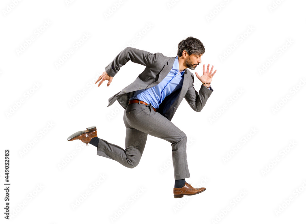 Stylish businessman running at speed in a mid air stride