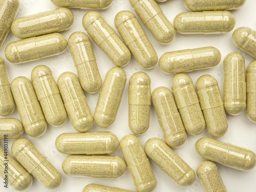 Full frame of Andrographis capsules isolated on a white background. Close-up photo. Space for text. Herbal, medicine, and healthcare concept