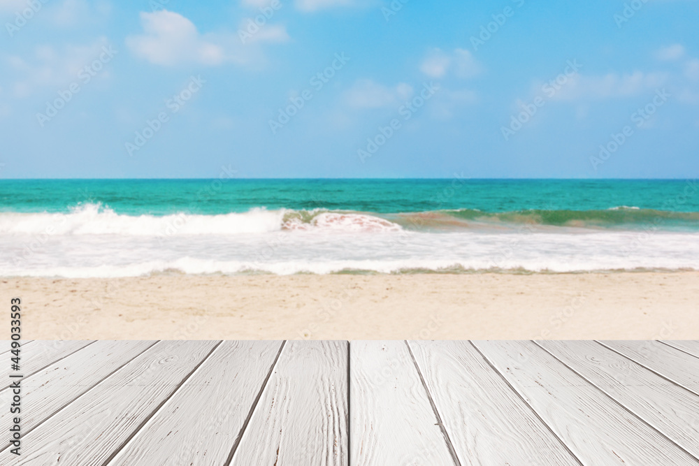 Fototapeta premium White Plank Wooden Table in front of Sea or Ocean Sand Beach Background . 3d Rendering
