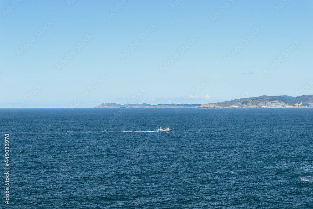 Blue view of fishermen boat returning in North sea from Spanish coast
