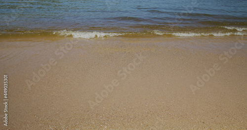 Sandy beach with calm sea wave