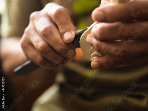 Luthier violinmaker scultping a classic violin curl photo