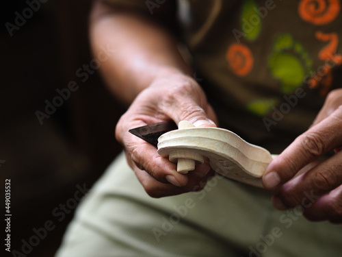 Luthier violinmaker scultping a classic violin curl photo