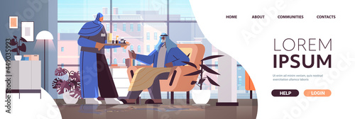 friendly arab nurse or volunteer bringing pills to arabic elderly man patient home care services healthcare