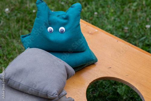 Corn hole or bean bag toss game board and bags with a fun and silly face
