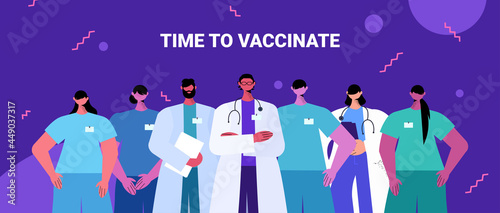 doctors team in uniform standing together medicine healthcare time to vaccinate concept