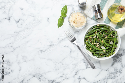 Tasty salad with green beans served on white marble table, flat lay. Space for text