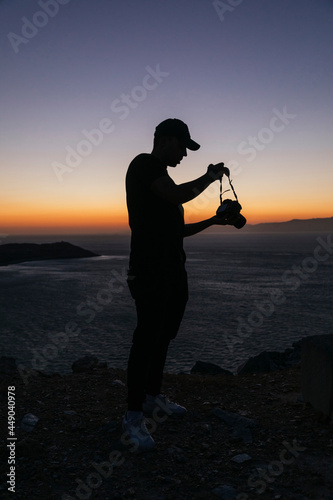 Un hombre excursionista mirando el atardecer junto a la frontera de Benzú photo