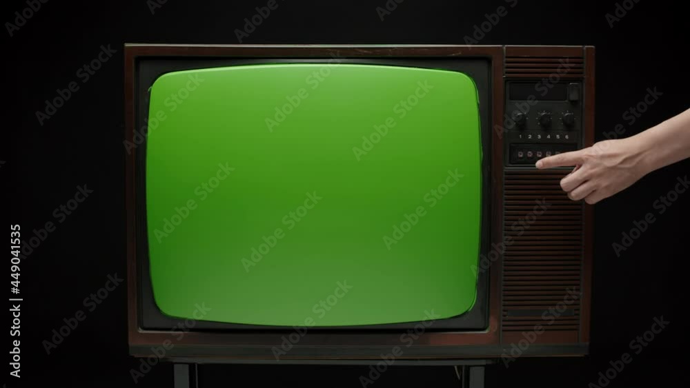 Old retro television with antenna on grey background. Broken old-fashioned TV screen with ripples on table, bad signal reception, cinematography concept.
