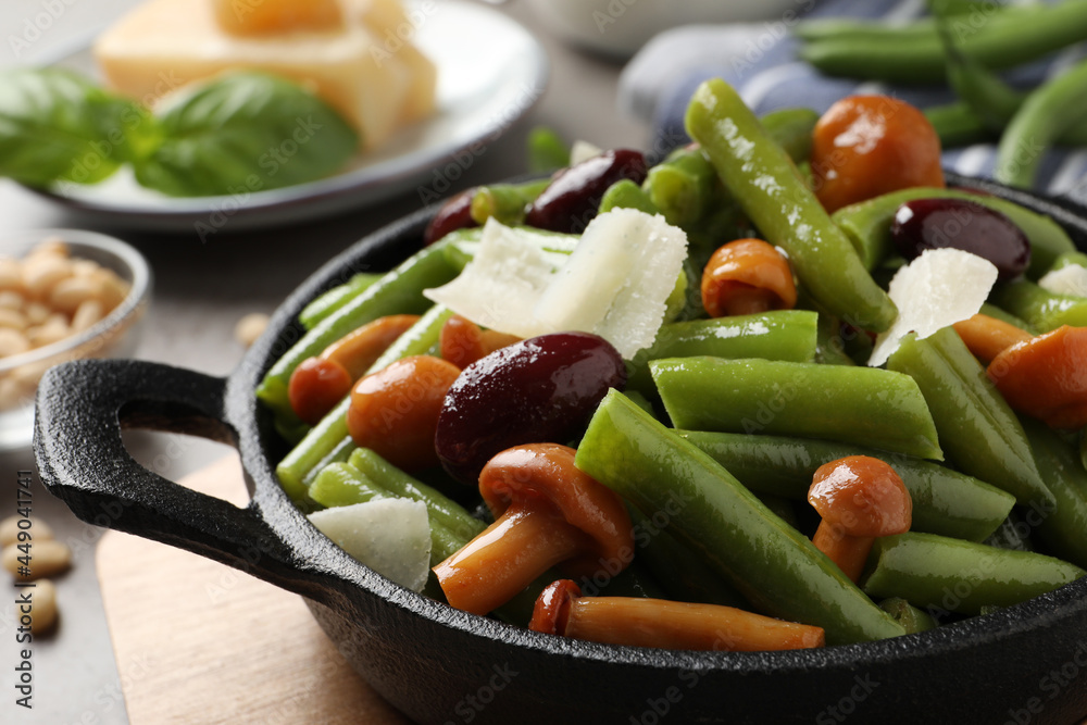 Delicious salad with green beans, mushrooms and cheese on table, closeup