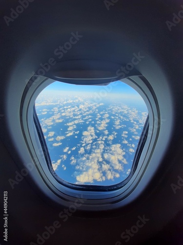 View of the clouds from a height through the airplane window.