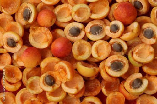 apricots halves with stones, rich apricots, fruit background