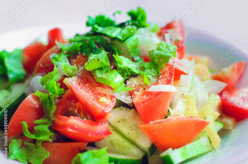 Delicious healthy vegetable salad in a white plate, close-up.