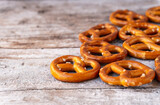Close-up of an assortment of pretzels with a little salt against a rustic wooden background.