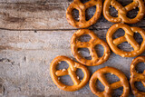 Close-up of an assortment of pretzels with a little salt against a rustic wooden background.
