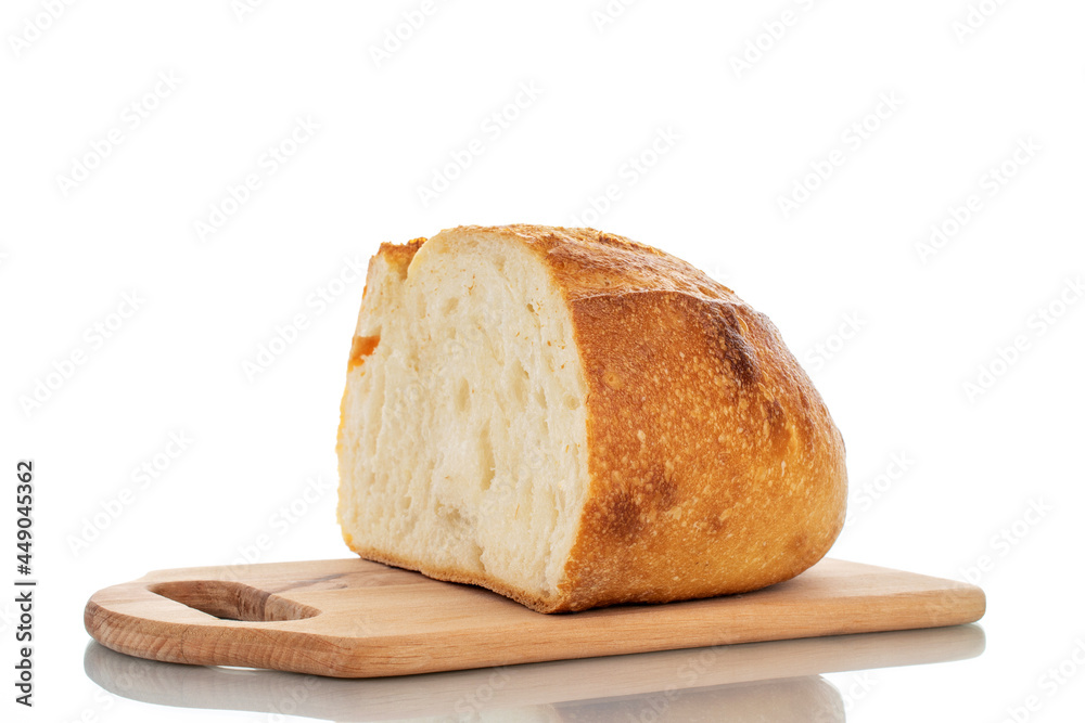 One halves of fragrant white bread on a wooden board, close-up, isolated on white.