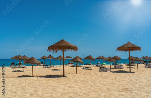 View of the luxury beach on the sea with sun loungers and umbrellas, in the tourist zone of the tropics. Sunny day