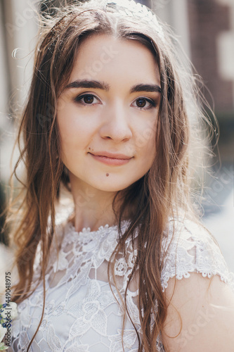 Portrait of beautiful bride in stylish vintage dress posing in sunny street of european city. Sensual bride in stylish gown in sunny light. Provence wedding