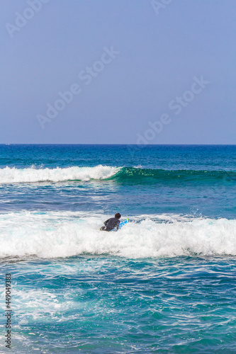 Surfer in waves Playa del Camisón Canary Spanish island Tenerife.