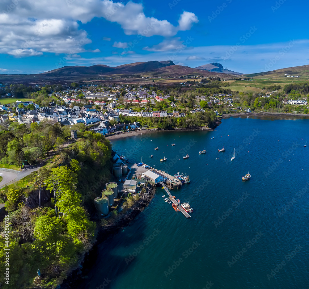 A panorama aerial view along the coast and the town of Portree on the Isle of Skye, Scotland on a summers day