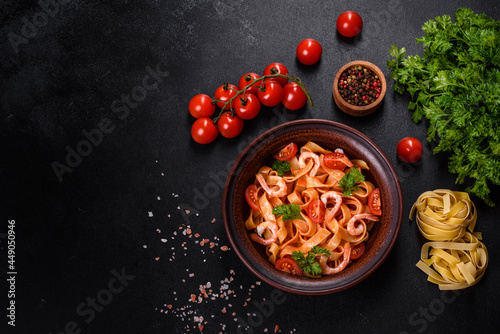 Fettuccine pasta with shrimp, cherry tomatoes, sauce, spices and herbs