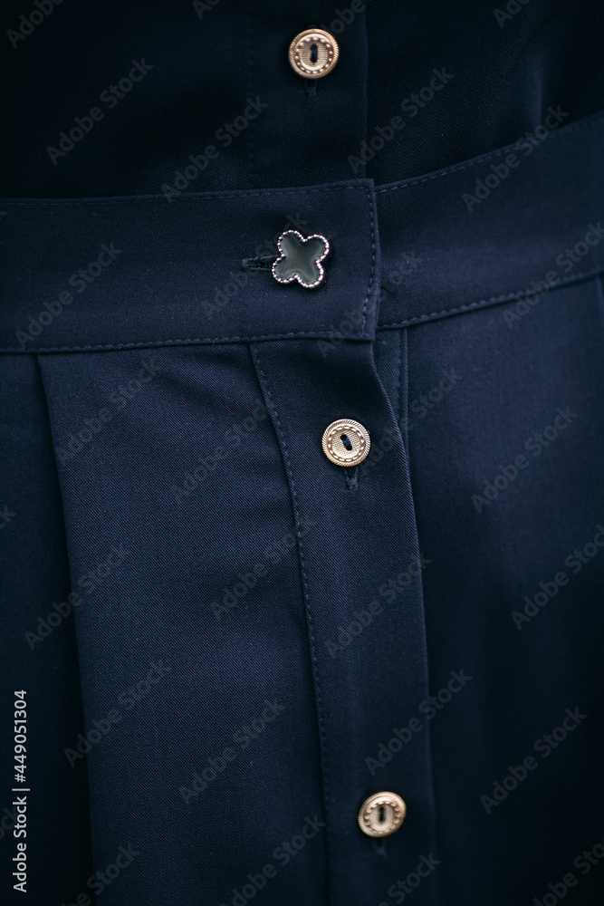 Part of a beautiful black dress made of dense fabric with neat tailoring and white buttons Part of a beautiful black dress made of dense fabric with neat tailoring and white buttons