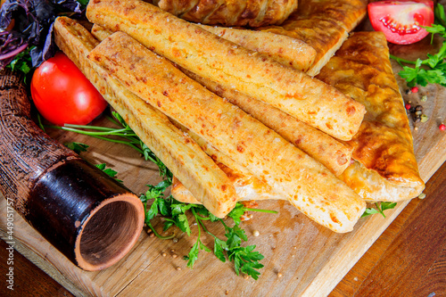 Traditional Georgian adjara khachapuri and Kolkh khachapuri on the table. Assorted Georgean bread. photo