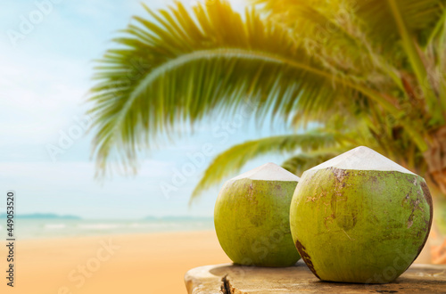 two coconuts By the beach for a refreshing drink in the summer.
