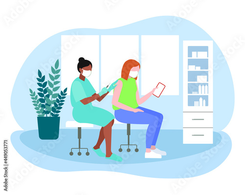 vaccination room, a woman doctor gives a vaccination to a woman with red hair