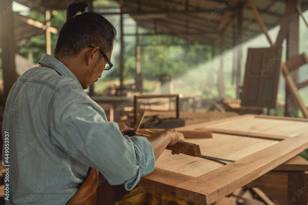 Carpenter working woodworking on the wooden desk