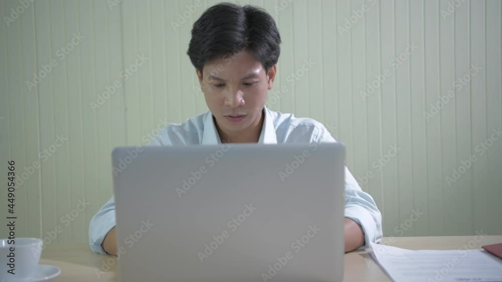 Business concept of 4k Resolution. Young Asian men searching for information using a computer. Business concept of 4k Resolution. Young Asian men searching for information using a computer.