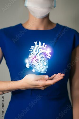 Unrecognizable woman in blue clothes holding highlighted handrawn Heart in hands. Medical illustration, template, science mockup.