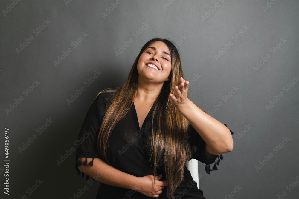 portrait of tender, happy and relaxed overweight latin young woman portrait of tender, happy and relaxed overweight latin young woman