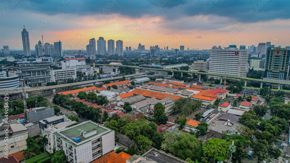 Obraz premium Aerial view of articulated city buses arriving and leaving at bus station near main railway station MRT line at Kebayoran Baru. Jakarta, Indonesia, Agustus 5, 2021