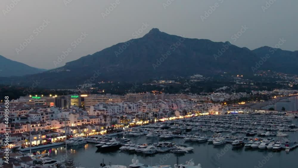 Aerial drone helicopter panoramic view of Puerto Banus Marbella marina luxury port in Spain at dusk Aerial drone helicopter panoramic view of Puerto Banus Marbella marina luxury port in Spain at dusk