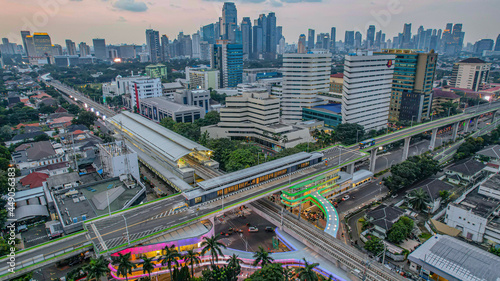 Fototapeta Naklejka Na Ścianę i Meble -  Aerial view of articulated city buses arriving and leaving at bus station near main railway station MRT line at Kebayoran Baru. Jakarta, Indonesia, Agustus 5, 2021