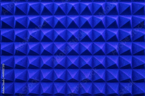 rows of acoustic music soundproof foam pyramid panel with blue lighting.