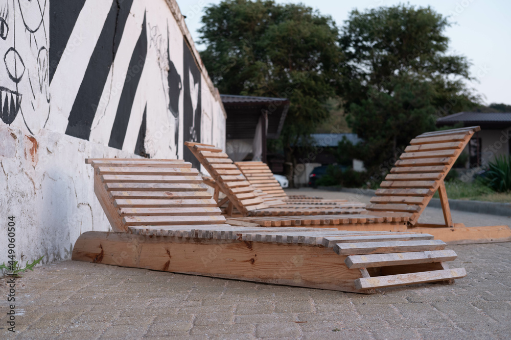 Empty sun loungers for the beach on the stone walkway in the hotel