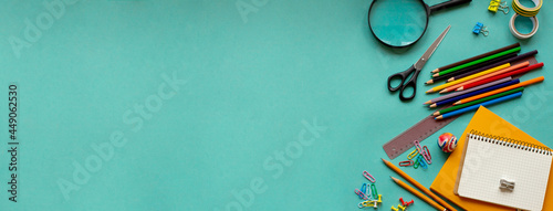 School supplies on a blue background. View from above. Copy space. photo