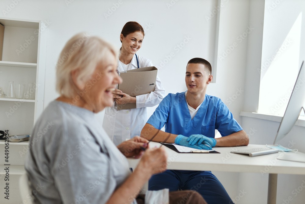 smiling woman patient in hospital communicates with doctor service