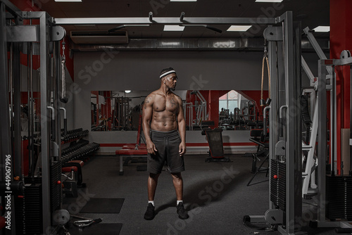 African american athletic guy with naked muscular torso standing in gym on training. Sport lifestyle, exercising concept