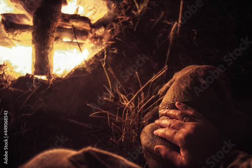 Man’s hand stroking his resting and sleeping pet dog friend in camping site nearby fireplace during hunting season concept dog and human friendship