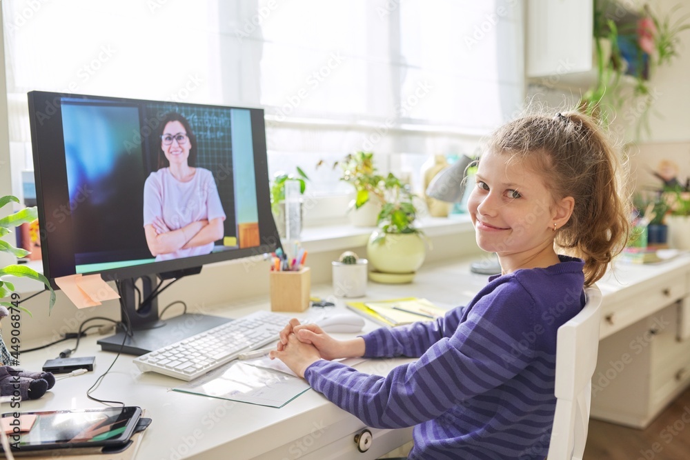 Preteen girl learning math online using home computer stock photo