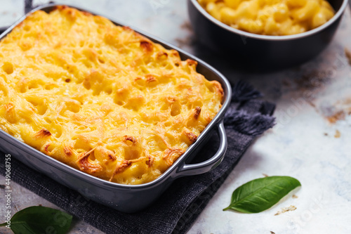 Mac and cheese baked in oven with basil leaves