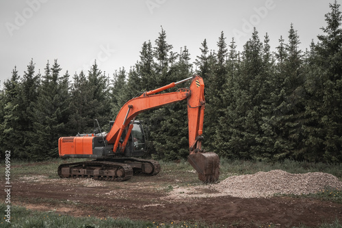 Excavator, earth mover at construction site
