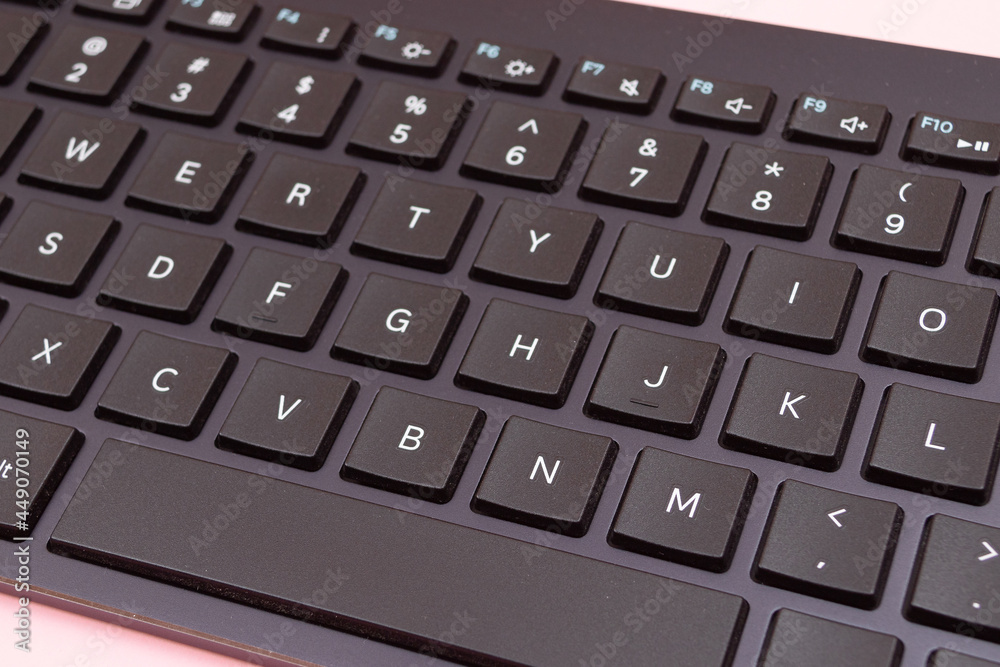 Black Bluetooth Keyboard for Tablet or PC on Pink Background